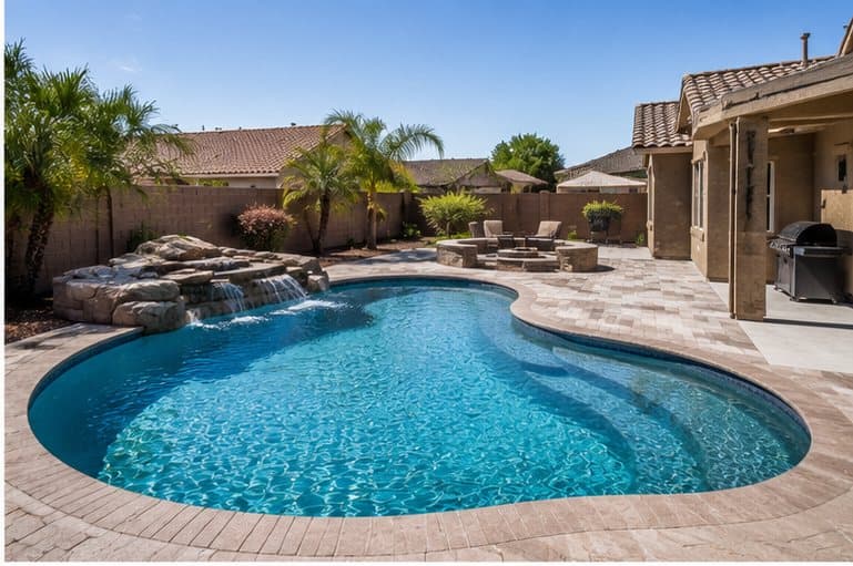 A freshly serviced backyard pool — clear, blue, swim-ready.